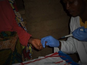 A technician from Sierra Leone's NTD Program takes capillary blood to test for lymphatic filariasis. Photo: HKI 
