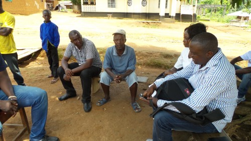 Members of Sierra Leone's NTD Program and the END in Africa team meet with Komende Luyama Village Chief Musa Lahai during the NTD MDA in his village. Photo: FHI360