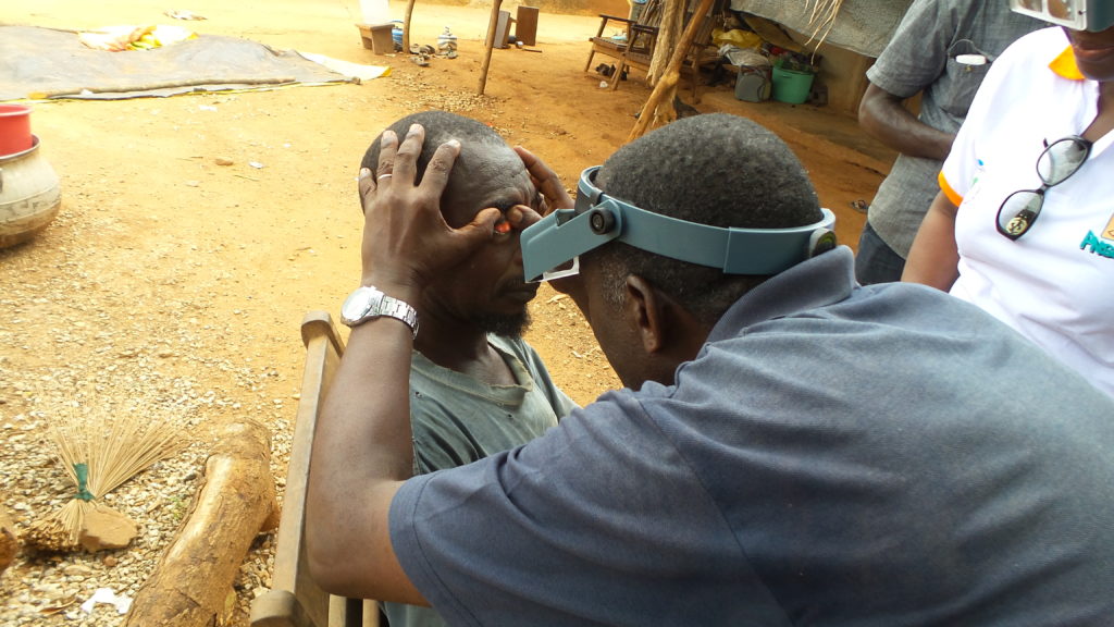 Ophthalmology technician exams man for trachoma. Photo: FHI 360