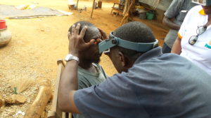 Ophthalmology technician exams man for trachoma in Côte d’Ivoire. Photo: FHI 360