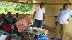 END in Africa Project Director Bolivar Pou views a skin snip test, looks for onchocerciasis. Photo: FHI 360 